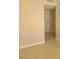 Neutral hallway featuring tile floors and leading to a white door at 1309 Exley Ave, Las Vegas, NV 89104