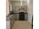 Modern kitchen featuring gray cabinets, a black gas range, and tile flooring at 1309 Exley Ave, Las Vegas, NV 89104