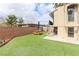 Back yard featuring a picnic table on green turf, with brick wall surround and staircase access to upper level at 1312 Georgia Ave # D, Boulder City, NV 89005