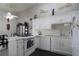 Well-lit kitchen offers white cabinets, modern appliances, and a breakfast bar for added functionality at 1312 Georgia Ave # D, Boulder City, NV 89005