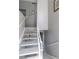 Bright stairwell with white wooden handrail, offering easy access to the upper levels of the home at 1312 Georgia Ave # D, Boulder City, NV 89005