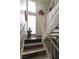 Well-lit stairwell leading to upper floors, featuring white railings and stylish decor throughout the home at 1312 Georgia Ave # D, Boulder City, NV 89005