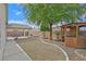 Large backyard includes gravel landscaping, stone trim, a covered patio, and a decorative wooden gazebo at 1326 Winter Solstice Ave, Henderson, NV 89014