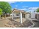 Enclosed backyard features a covered patio with a decorative rock garden and a detached storage shed at 1326 Winter Solstice Ave, Henderson, NV 89014