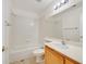 Bathroom featuring a single sink vanity and a bathtub with shower with all white tiles at 1326 Winter Solstice Ave, Henderson, NV 89014