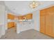 Bright eat-in kitchen featuring ample wood cabinets, breakfast bar, and tile flooring at 1326 Winter Solstice Ave, Henderson, NV 89014