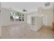 Spacious living room with large windows, tile floors, ceiling fan, and built-in shelving at 1326 Winter Solstice Ave, Henderson, NV 89014