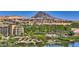 Stunning aerial view showcases a serene lake and golf course community with mountain views at 21 Via Visione # 101, Henderson, NV 89011