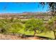 Scenic backyard view of mountains, golf course, and lush landscaping at 21 Via Visione # 101, Henderson, NV 89011