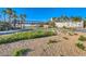 Lake Las Vegas entrance features lush landscaping and pedestrian bridge with a backdrop of clear blue sky at 21 Via Visione # 101, Henderson, NV 89011