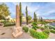 Landscaped community entrance with elegant signage and towering trees, providing a welcoming and sophisticated ambiance at 21 Via Visione # 101, Henderson, NV 89011
