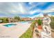 Community pool and spa area featuring well-maintained landscaping, lounge chairs, and statues in a serene setting at 21 Via Visione # 101, Henderson, NV 89011