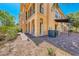 Exterior of a home with a covered patio, arched columns, and professional landscaping at 21 Via Visione # 101, Henderson, NV 89011