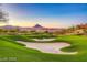 Scenic golf course view with rolling green hills, sand traps, and mountains in the background at 21 Via Visione # 101, Henderson, NV 89011