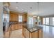 Open kitchen with stainless appliances and a center island with a wine cooler at 21 Via Visione # 101, Henderson, NV 89011