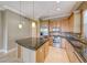 Modern kitchen featuring stainless steel appliances and granite countertops at 21 Via Visione # 101, Henderson, NV 89011