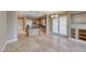 Open-concept living area showcasing a kitchen with an island, stainless appliances, and wooden cabinets at 21 Via Visione # 101, Henderson, NV 89011