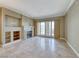 Bright living room with a fireplace, travertine floors, and sliding doors at 21 Via Visione # 101, Henderson, NV 89011