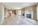 Spacious living area featuring travertine floors, a fireplace, and an open layout at 21 Via Visione # 101, Henderson, NV 89011