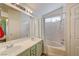 Bathroom featuring double sinks, a large mirror, and a shower-tub combination at 2308 Avery Dr, Las Vegas, NV 89108