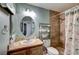 Charming bathroom with granite countertops, decorative mirror, and tiled shower with modern fixtures at 2308 Avery Dr, Las Vegas, NV 89108