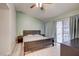 Relaxing bedroom with a ceiling fan and sliding glass door to the backyard at 2308 Avery Dr, Las Vegas, NV 89108