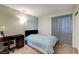 Bedroom with a desk and chair, hardwood floors, and large window at 2308 Avery Dr, Las Vegas, NV 89108
