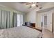 Bedroom featuring wood-look floors, ensuite bathroom, and sliding glass door to the backyard at 2308 Avery Dr, Las Vegas, NV 89108