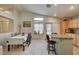 Bright dining area with a long table, bar seating, and modern lighting fixtures at 2308 Avery Dr, Las Vegas, NV 89108