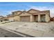 Inviting single-story home with a two-car garage, desert landscaping, and covered entryway at 2308 Avery Dr, Las Vegas, NV 89108