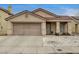 Charming single-story home featuring a two-car garage, desert landscaping, and a cozy front porch at 2308 Avery Dr, Las Vegas, NV 89108