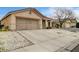 Single-story home with a two-car garage, desert landscaping, and a long driveway at 2308 Avery Dr, Las Vegas, NV 89108