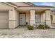 Welcoming front porch featuring decorative columns, security door, and desert landscaping at 2308 Avery Dr, Las Vegas, NV 89108