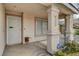 Front porch close-up showcasing the security door, concrete columns, and desert landscaping at 2308 Avery Dr, Las Vegas, NV 89108