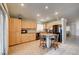 Bright kitchen with wooden cabinets, granite counters, and an island with bar seating at 2308 Avery Dr, Las Vegas, NV 89108