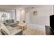 Living room featuring tile floors, neutral paint, and comfortable seating arrangement at 2308 Avery Dr, Las Vegas, NV 89108
