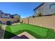 Landscaped backyard featuring a putting green, brick patio, and seating area at 2685 Conifer Canyon St, Henderson, NV 89044