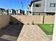 Paver patio with a putting green, privacy walls, and xeriscaping at 2685 Conifer Canyon St, Henderson, NV 89044