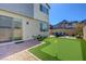 Backyard features a putting green, seating area, and privacy wall at 2685 Conifer Canyon St, Henderson, NV 89044