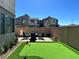 Backyard putting green with a table, chairs, privacy walls, and views of the neighborhood at 2685 Conifer Canyon St, Henderson, NV 89044