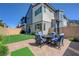 Charming backyard with putting green, brick patio, dining table and well manicured landscaping at 2685 Conifer Canyon St, Henderson, NV 89044