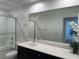Bright bathroom featuring shower, tile flooring, and modern vanity with quartz countertop at 2685 Conifer Canyon St, Henderson, NV 89044