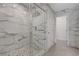 Shower in a modern bathroom with marble tiling and glass enclosed shower  at 2685 Conifer Canyon St, Henderson, NV 89044