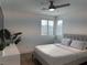 Neutral bedroom featuring a ceiling fan, a view of the neighborhood, and a comfortably sized bed at 2685 Conifer Canyon St, Henderson, NV 89044