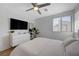 Clean bedroom featuring TV, white dresser, large mirror, and plenty of natural light at 2685 Conifer Canyon St, Henderson, NV 89044