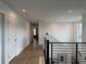 Bright hallway with modern railing, hard wood flooring, and recessed lighting at 2685 Conifer Canyon St, Henderson, NV 89044