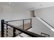 Upstairs hallway with wood flooring, iron railing and view to downstairs at 2685 Conifer Canyon St, Henderson, NV 89044