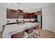 Elegant open kitchen with wood cabinets, stainless steel appliances, light countertops and island seating at 2685 Conifer Canyon St, Henderson, NV 89044