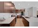 Open kitchen features wood cabinets, stainless steel appliances, light countertops and wood floor at 2685 Conifer Canyon St, Henderson, NV 89044