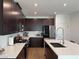 This kitchen features dark wood cabinetry and white quartz countertops at 2685 Conifer Canyon St, Henderson, NV 89044